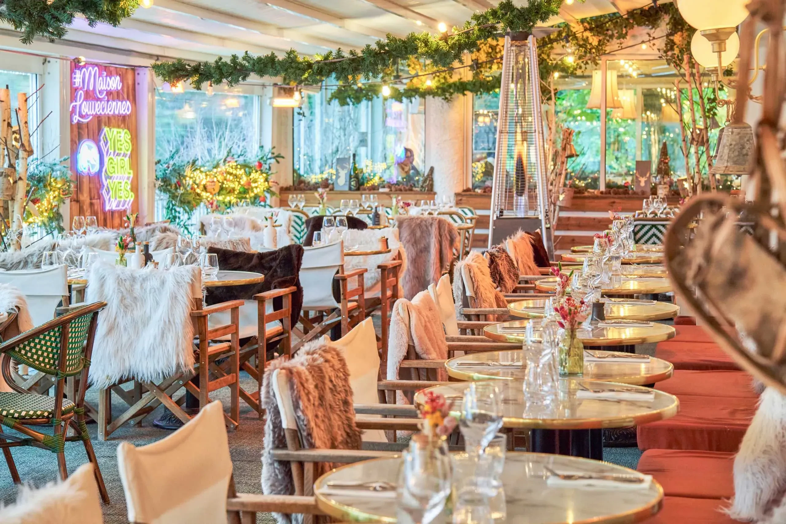 Restaurant décoré pour Noël avec tables élégantes.